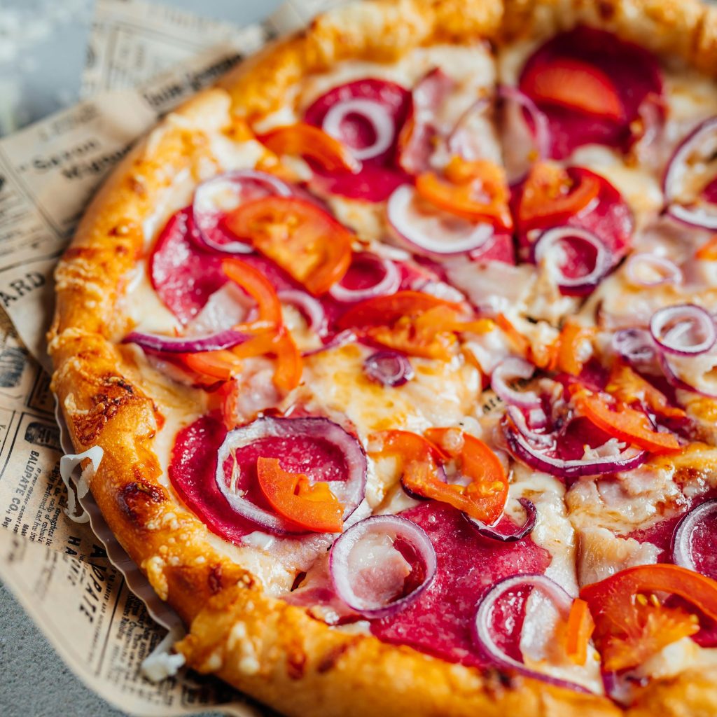 Freshly baked pizza on a vintage paper tray with a newspaper